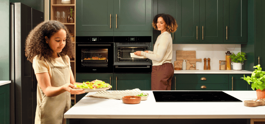 Hotpoint kitchen scene with family cooking Purpl disabled discounts members save on home appliances and oven deals.