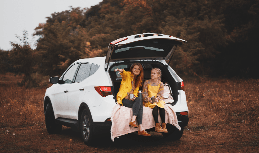Woman and child sitting in open car boot, Accessible Vehicle Club, Purpl discounts for disabilities and long term health conditions, disabled travel discounts UK.