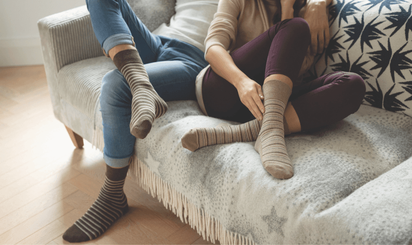 Two people relaxing in striped socks, Gentle Grip Purpl discounts for disabilities and long term health conditions, mobility discounts and offers.