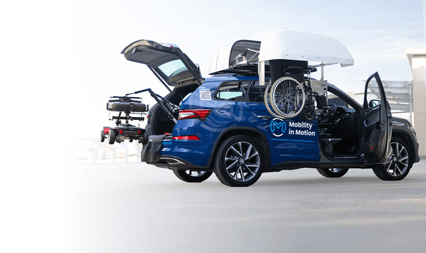 Mobility adapted car with powered scooter lift and accessible wheelchair roof storage.