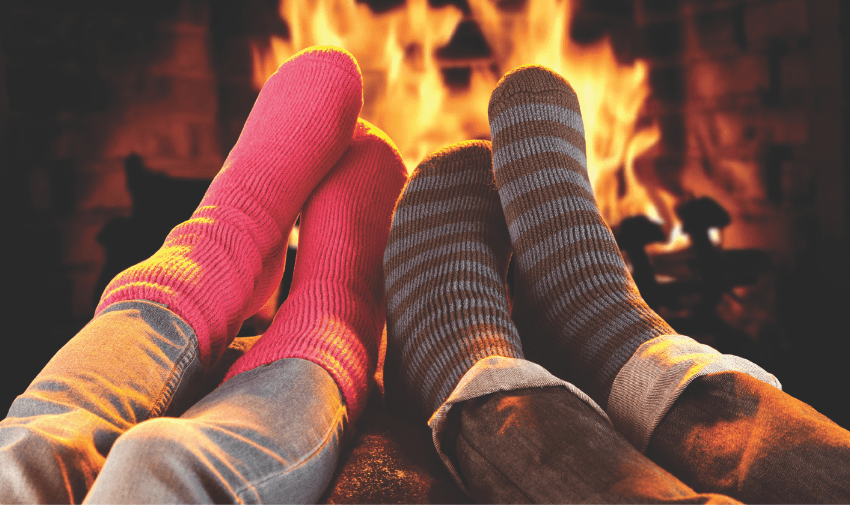 Cosy feet in striped socks by fire, Heat Holders Purpl discounts for disabilities and long term health conditions, mobility discounts and offers.