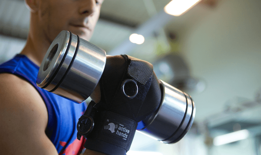 Man lifting dumbbell with Active Hands grip, Purpl discounts for disabilities and long term health conditions, mobility discounts and offers.