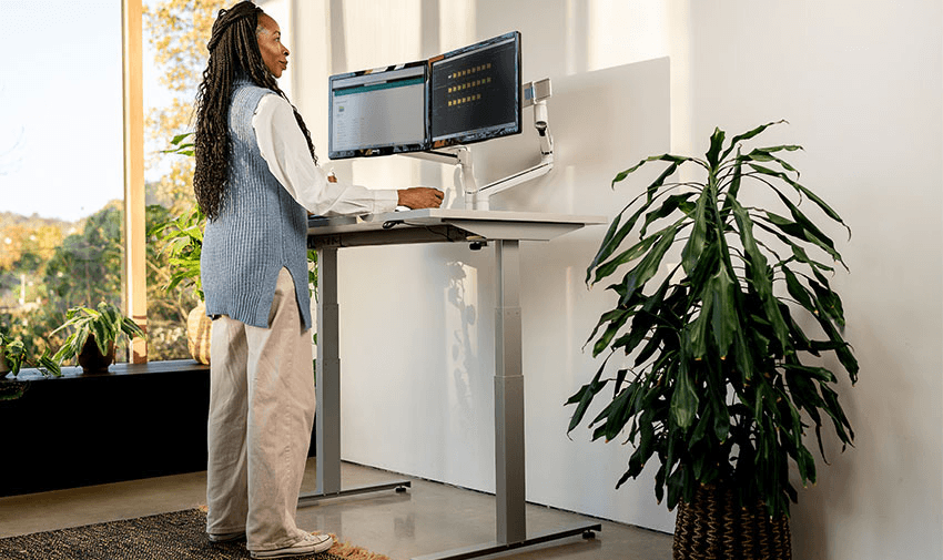 Woman using standing desk at Posturite, Purpl discounts for disabilities and long term health conditions, mobility discounts and offers.