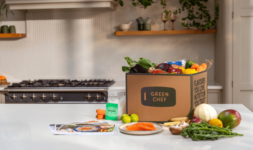 A Green Chef box overflowing with fresh ingredients on a kitchen counter, highlighting shopping discounts for disabled people.