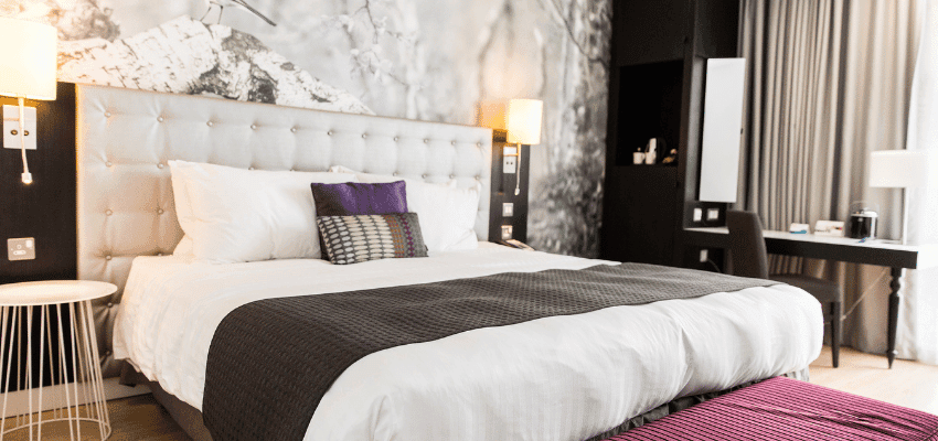 Modern hotel bedroom with double bed, Holiday Extras Purpl discounts for disabilities and long term health conditions, disabled travel discounts UK.