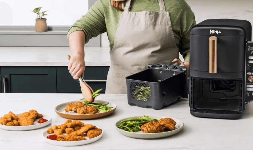 Person plating air-fried food in kitchen, Currys Purpl discounts for disabilities and long term health conditions, mobility discounts and offers.