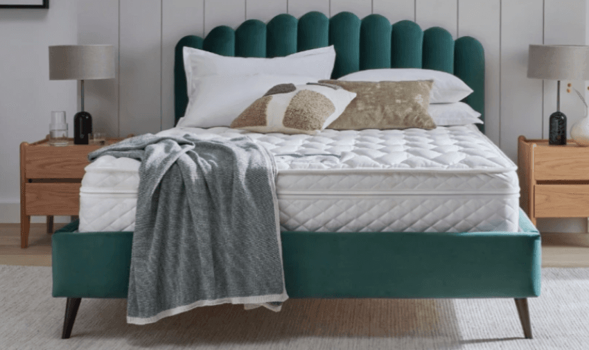 Made-up bed with teal headboard, Premier Inn at Home, Purpl discounts for disabilities and long term health conditions, shopping discounts for disabled people.