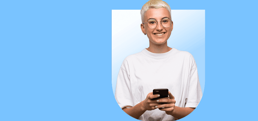 Smiling young person holding mobile phone on blue background promoting mobile phone deals with disabled discounts in the UK