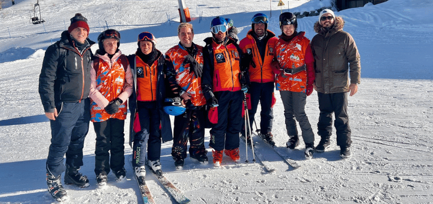 Seable adaptive skiing group with disabled travellers enjoying inclusive winter sports and accessible adventure travel