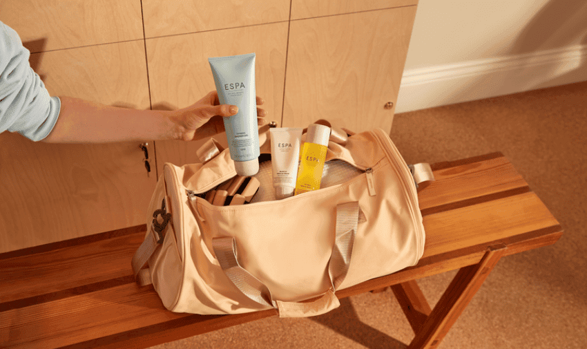 Hand placing ESPA Skincare products in a gym bag, Purpl discounts for disabilities and long term health conditions, mobility discounts and offers.