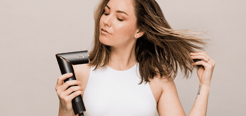 Woman blow-drying her hair, Shark UK Purpl discounts for disabilities and long term health conditions, mobility discounts and offers.