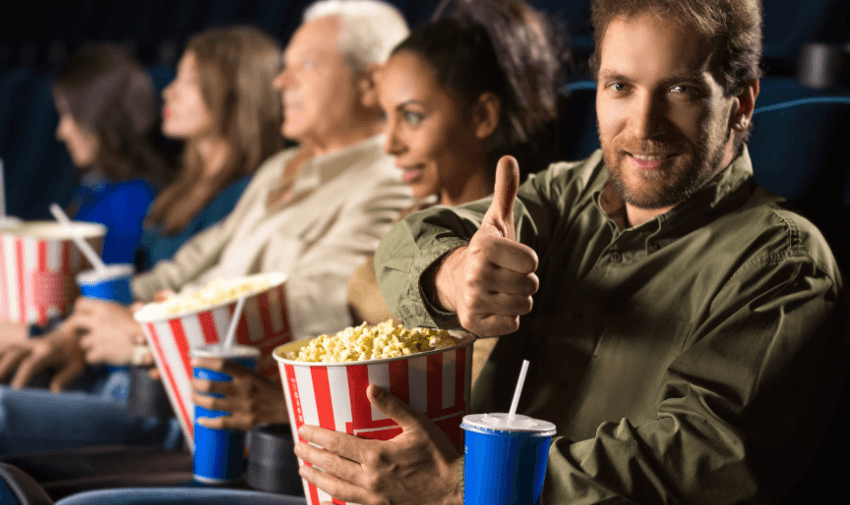 Cinema-goers with popcorn at Merlin Cinemas, Purpl discounts for disabilities and long term health conditions, mobility discounts and offers.