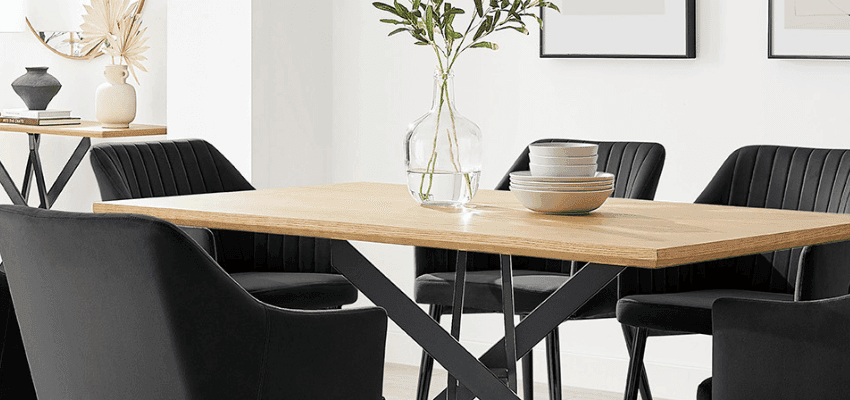 Modern dining table with black chairs and a glass vase in a bright white room Purpl discounts shopping discounts for disabled people accessibility discounts UK mobility discounts and offers savings for people with long term health conditions cost of living help for disabled people
