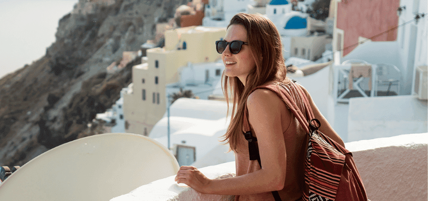 Woman overlooking Santorini rooftops, Holiday Extras Purpl discounts for disabilities and long term health conditions, disabled travel discounts UK.