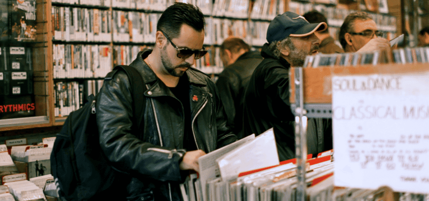 Customer browsing vinyl records in RareVinyl shop, Purpl discounts for disabilities and long term health conditions, shopping discounts for disabled people.
