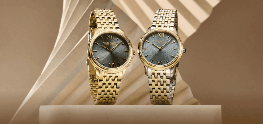 Two Olivia Burton gold and silver watches displayed on a stand, shown for Purpl discounts to help people with disabilities and long term health conditions save on everyday essentials.