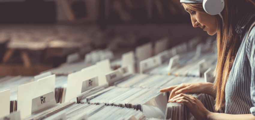Woman browsing vinyl records at RareVinyl, Purpl discounts for disabilities and long term health conditions, shopping discounts for disabled people.