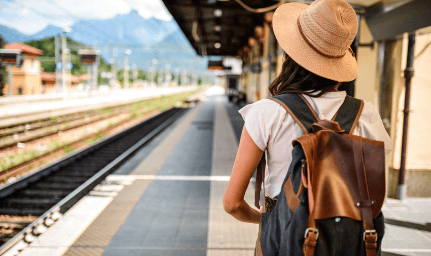 Traveller with backpack on station platform, TrainPal Purpl discounts for disabilities and long term health conditions, disabled travel discounts UK.
