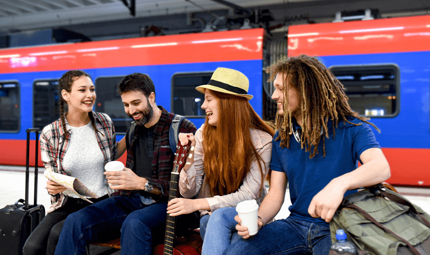 Friends waiting by a train, TrainPal Purpl discounts for disabilities and long term health conditions, disabled travel discounts UK.