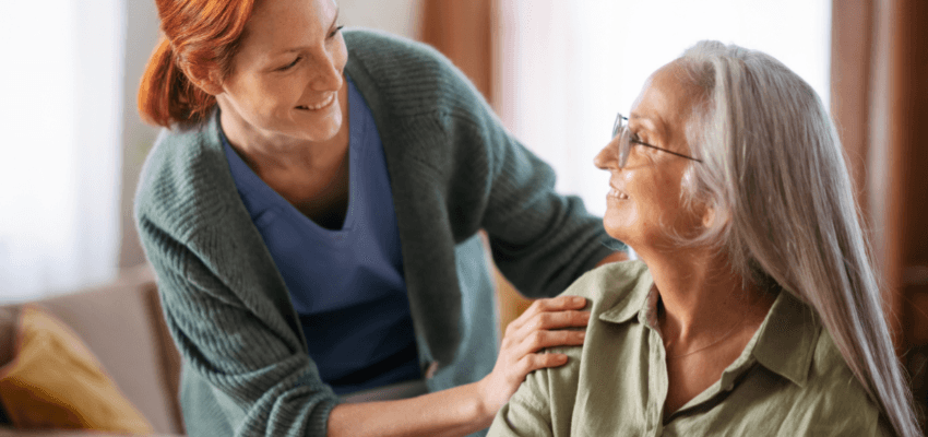 Smiling carer supporting older woman at home, County Cousins Shopping Discounts for Disabled People and Carer Savings UK.