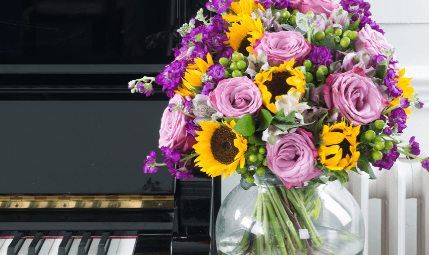 Bright bouquet by piano, Appleyard London Purpl discounts for disabilities and long term health conditions, shopping discounts for disabled people.