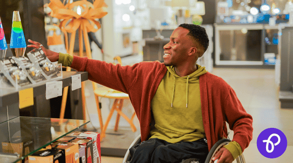 Disabled shopper browsing in store, highlighting Purpl's exclusive disability discounts that help save money on everyday shopping and independent living essentials.