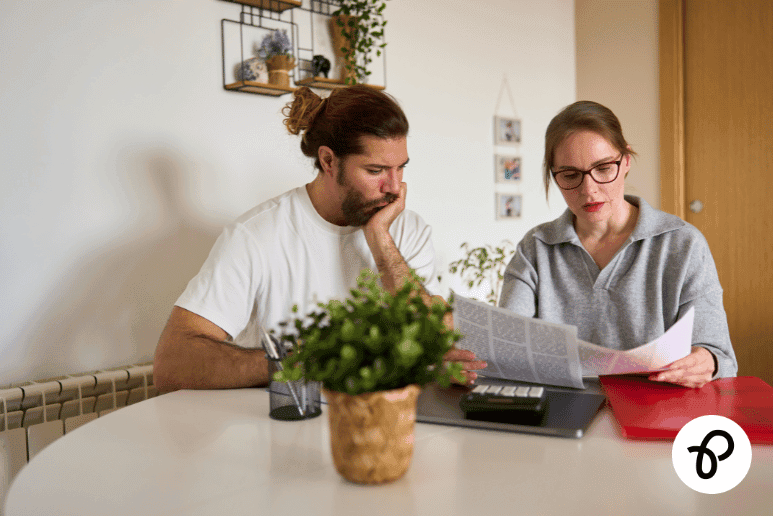 Couple reviewing disability benefit paperwork at home, relating to UK disability benefit reviews and long-term health condition support.